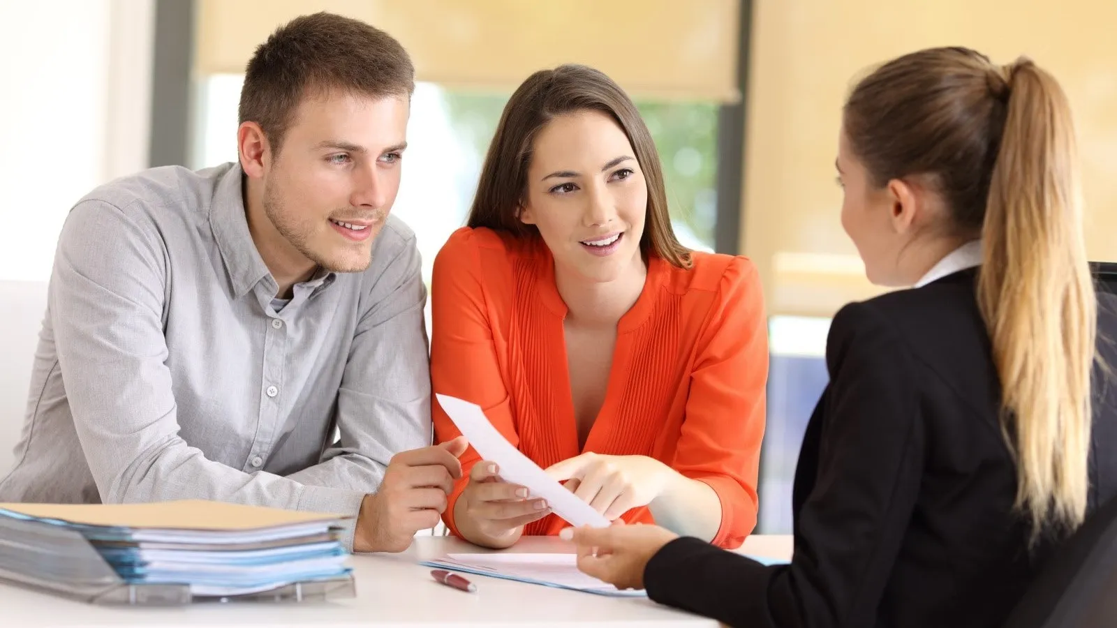 Two customers working with a financial rep